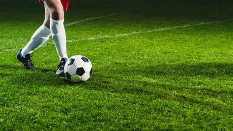Joueur de foot dribblant le ballon